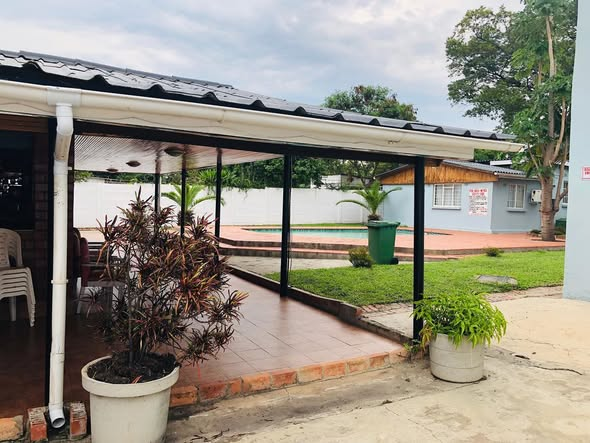 Covered outdoor veranda with potted plants